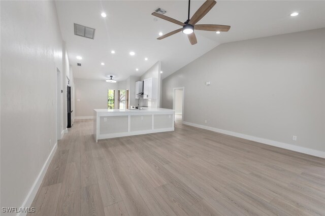 unfurnished living room featuring ceiling fan, high vaulted ceiling, and light hardwood / wood-style flooring