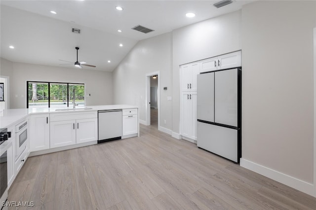 kitchen with white cabinets, fridge, dishwasher, and light wood-type flooring