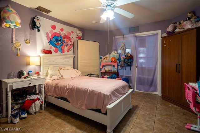 tiled bedroom featuring ceiling fan