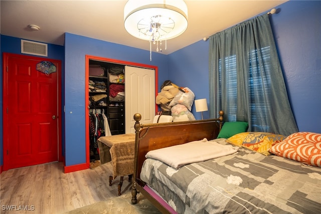 bedroom featuring light wood-type flooring and a closet