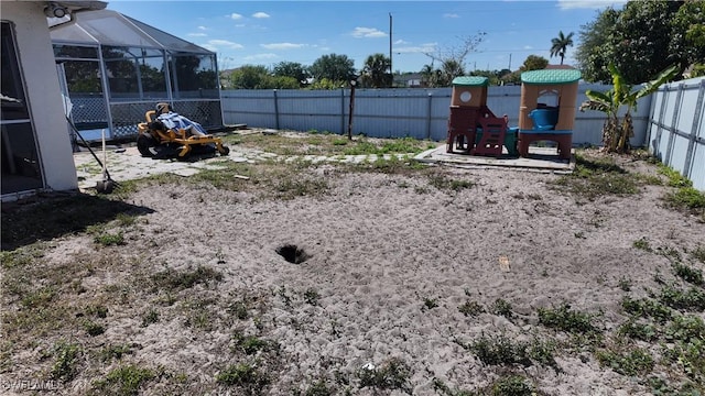 view of yard with a lanai and a fenced backyard