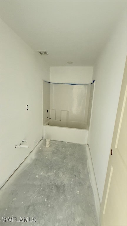 bathroom featuring a bathing tub and concrete flooring