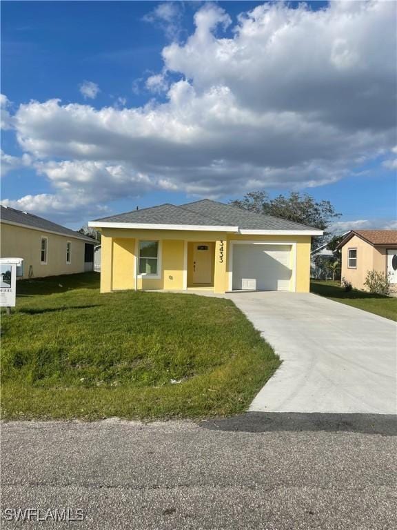 view of front of property with a garage and a front yard