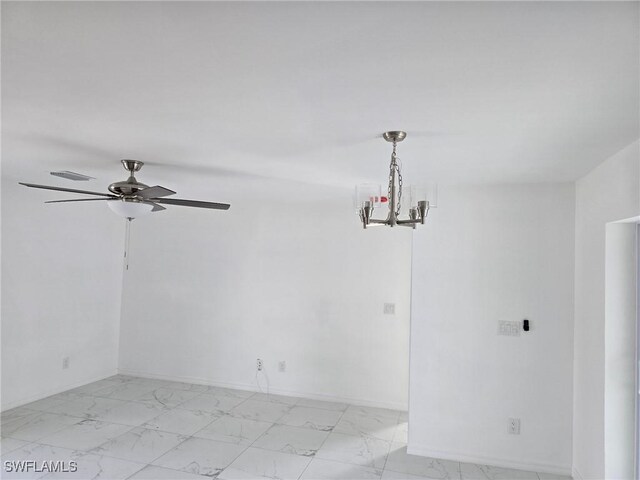 empty room featuring ceiling fan with notable chandelier