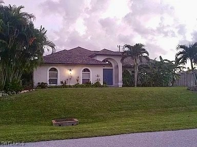 mediterranean / spanish house with a front yard