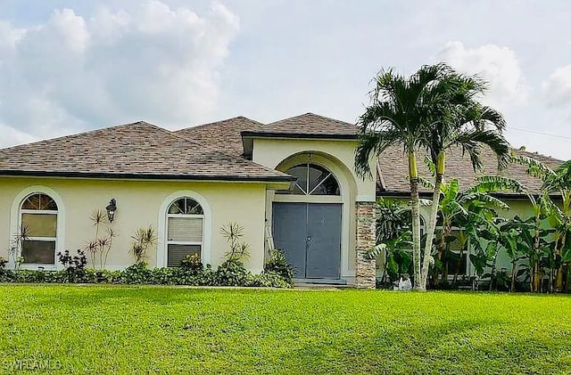 mediterranean / spanish home with a front lawn