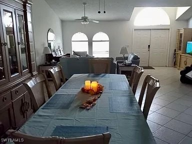 tiled dining room featuring ceiling fan