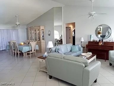 living room featuring high vaulted ceiling, ceiling fan, and light tile patterned floors