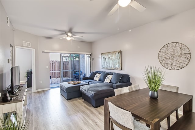 living room featuring light wood-type flooring and ceiling fan