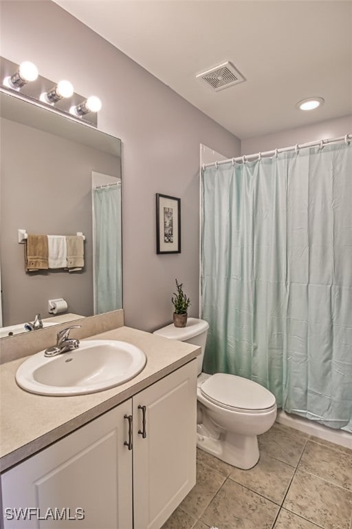 bathroom featuring vanity, curtained shower, toilet, and tile patterned floors