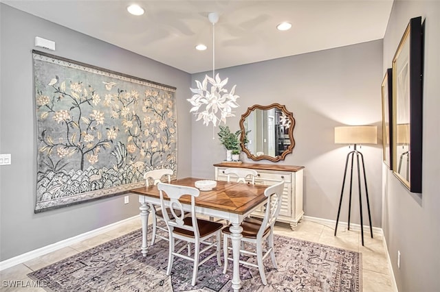 tiled dining room with an inviting chandelier