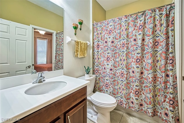 bathroom with a shower with shower curtain, tile patterned flooring, vanity, and toilet