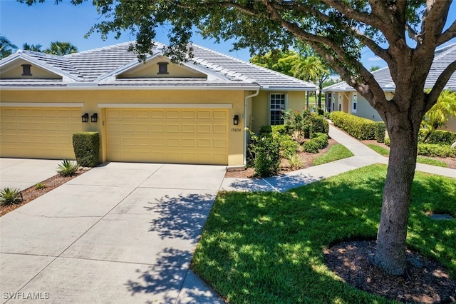 single story home with a front yard and a garage