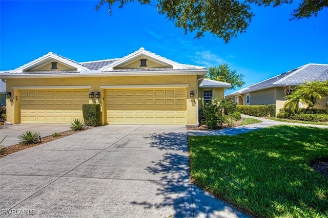 single story home featuring a garage and a front lawn