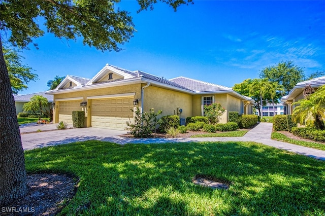 view of front of house with a front yard and a garage