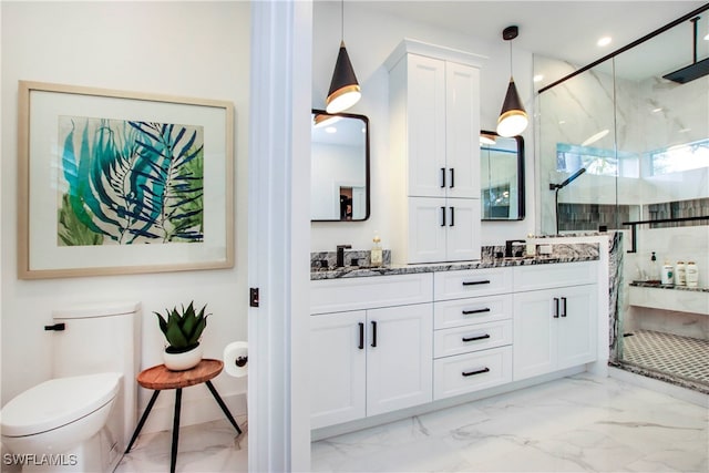 bathroom with a shower with door, vanity, and toilet