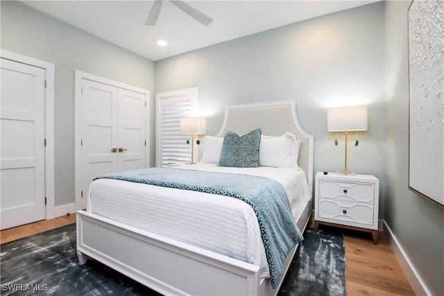 bedroom with ceiling fan and dark wood-type flooring