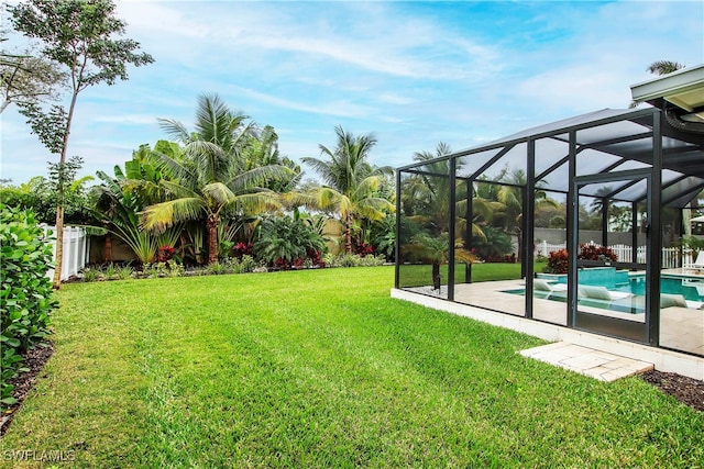 view of yard featuring a patio and a lanai