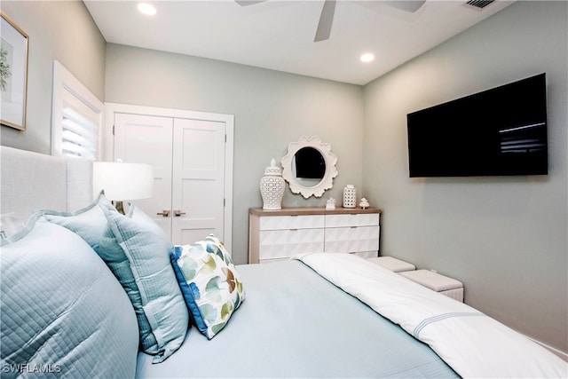 bedroom with ceiling fan and a closet