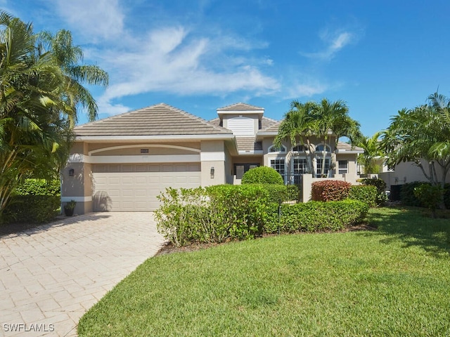 view of front facade with a front lawn and a garage