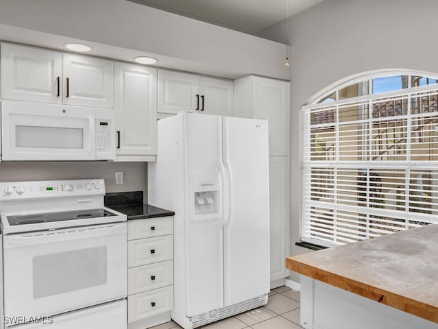 kitchen featuring white appliances, white cabinetry, and light tile patterned floors