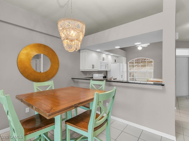 tiled dining space with an inviting chandelier