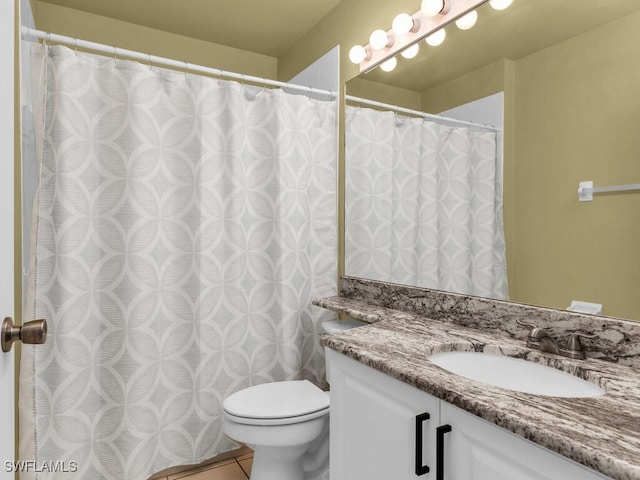 bathroom with vanity, toilet, and tile patterned floors