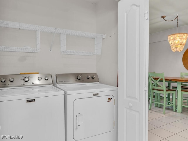 washroom featuring light tile patterned floors and washing machine and clothes dryer