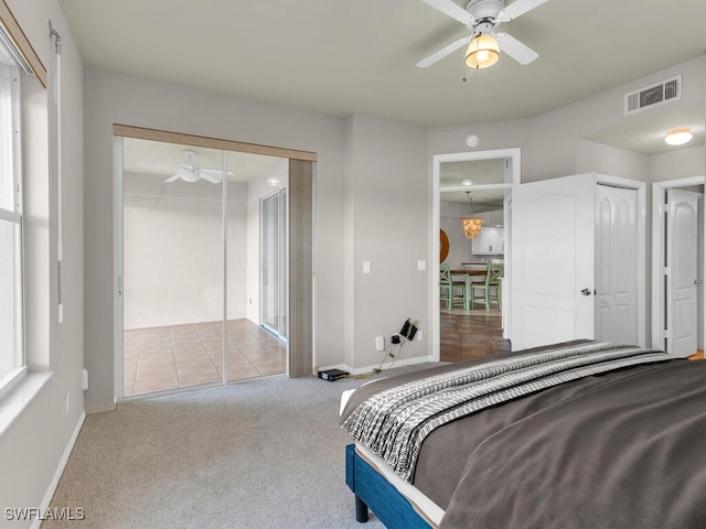 bedroom with ceiling fan and light carpet