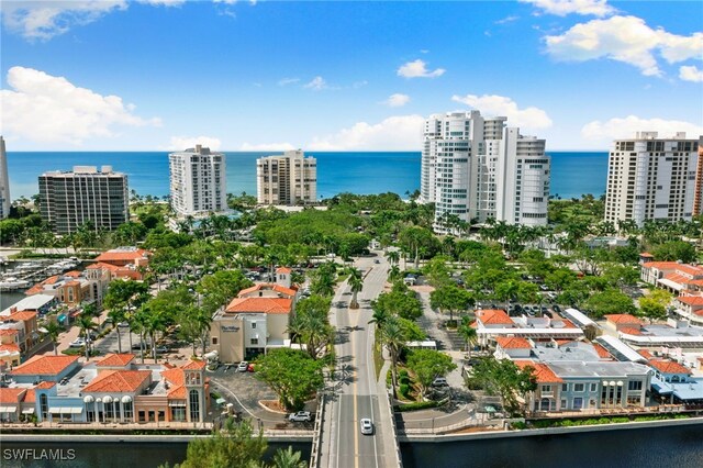 birds eye view of property featuring a water view and a city view