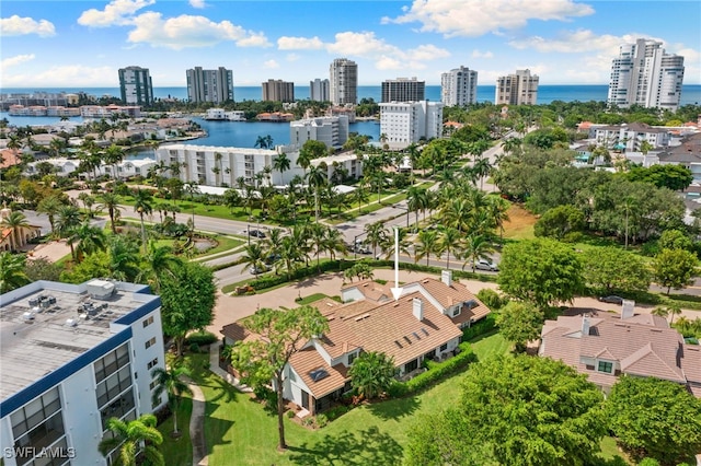 birds eye view of property with a view of city and a water view