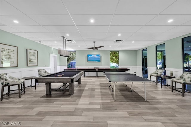 rec room with pool table, a paneled ceiling, and light hardwood / wood-style floors