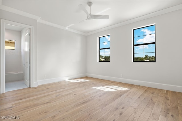 empty room featuring crown molding, light wood-type flooring, and ceiling fan