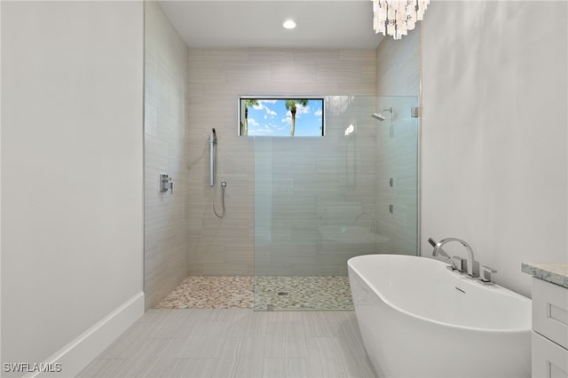 bathroom featuring vanity, plus walk in shower, and tile patterned floors