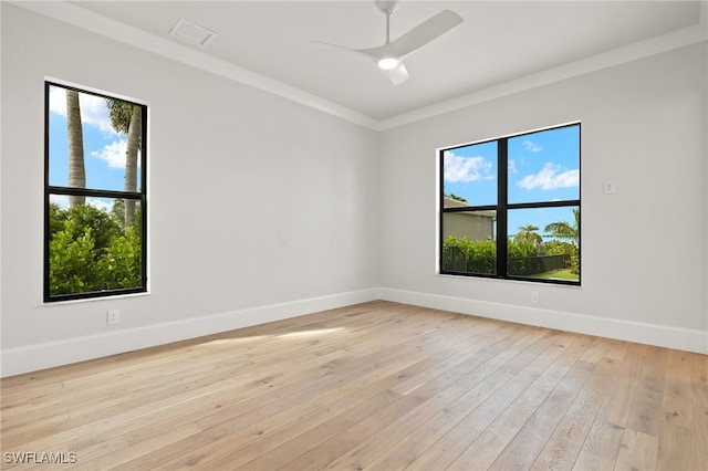 unfurnished room featuring crown molding, light hardwood / wood-style flooring, and plenty of natural light