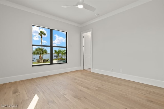 spare room with light hardwood / wood-style floors, ornamental molding, and ceiling fan