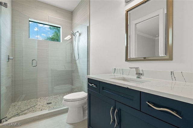 bathroom with toilet, an enclosed shower, and vanity