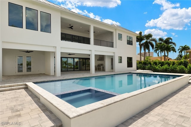 view of pool with a patio, ceiling fan, french doors, and an in ground hot tub