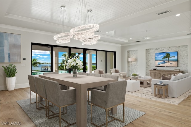 dining space with wooden ceiling, crown molding, an inviting chandelier, light wood-type flooring, and a water view