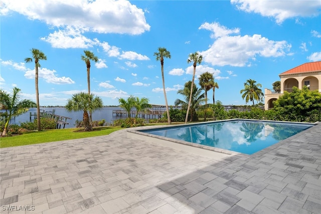 view of pool featuring a patio and a yard