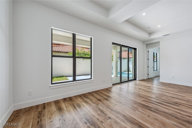 unfurnished room with hardwood / wood-style floors