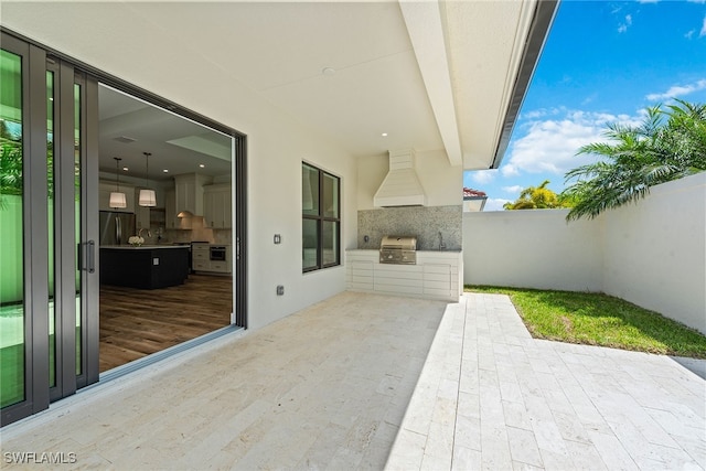 view of patio / terrace with area for grilling, sink, and exterior kitchen