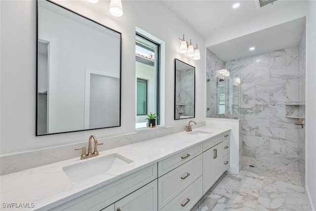 bathroom with vanity and tiled shower