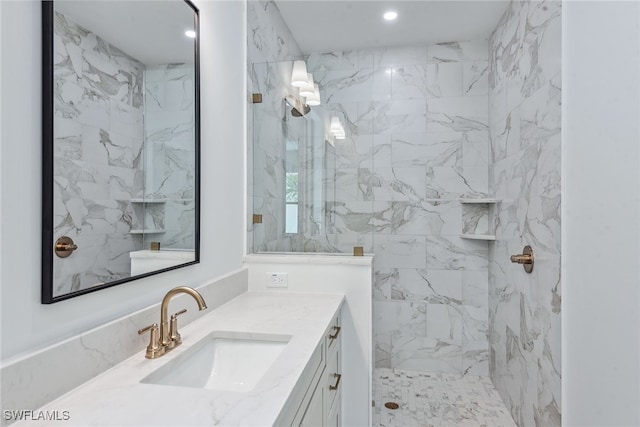 bathroom with vanity and a tile shower