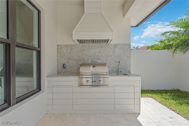 view of patio / terrace featuring area for grilling, sink, and grilling area