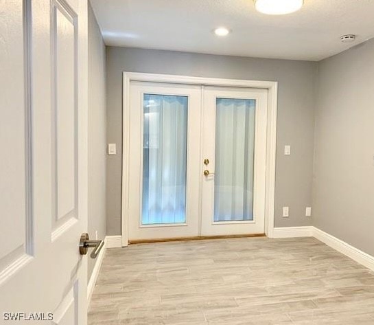 doorway featuring french doors and light wood-type flooring