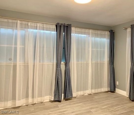 spare room featuring light hardwood / wood-style flooring