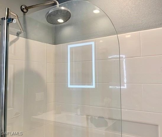 bathroom with a tile shower