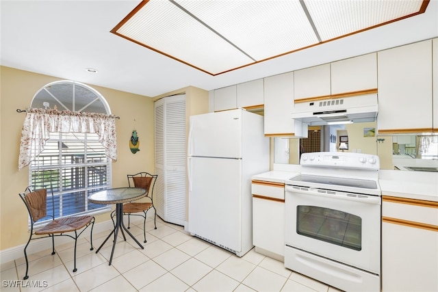 kitchen featuring white cabinets, white appliances, and light tile patterned flooring