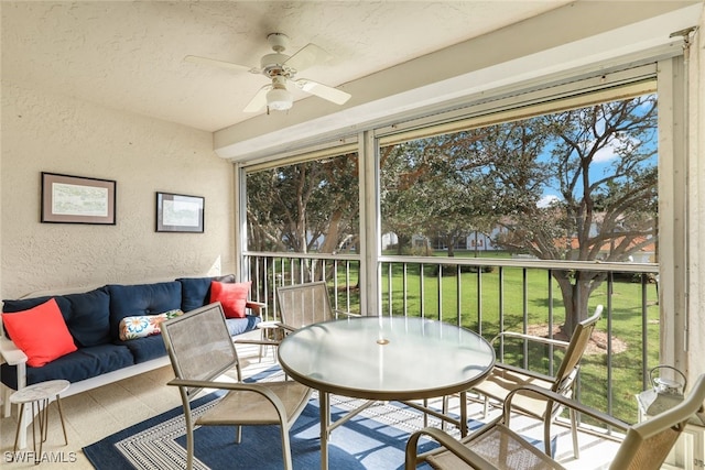 sunroom with ceiling fan and a wealth of natural light